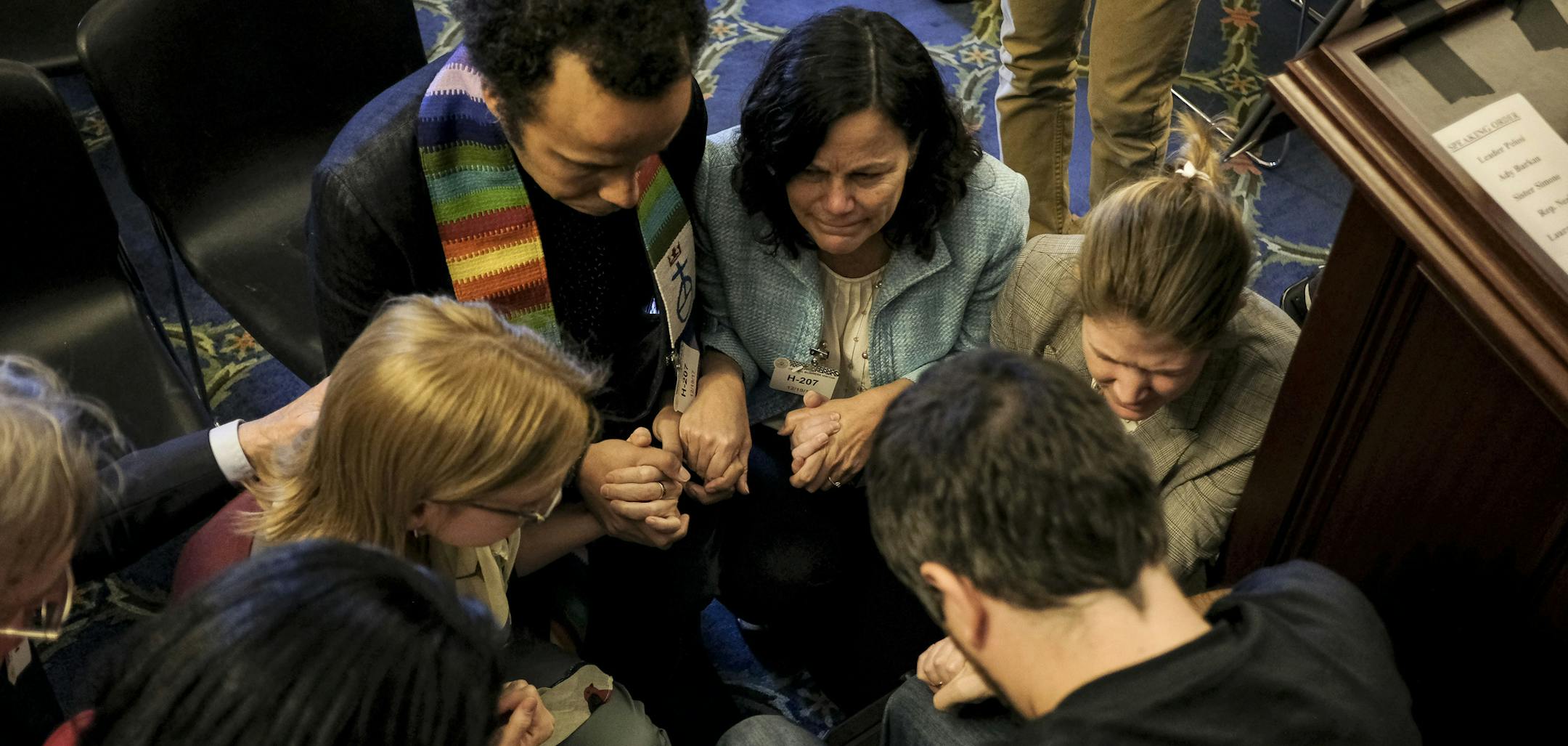 Religious leaders form a prayer circle around Ady Barkan, who has ALS, after a Democratic news conference on the Republican tax plan and its affect on health care on Capitol Hill in Washington, Dec. 19, 2017. The House on Tuesday approved the most sweeping tax overhaul in decades, voting along party lines to enact deep and permanent tax cuts for corporations and temporary cuts for individuals. (Gabriella Demczuk/The New York Times)