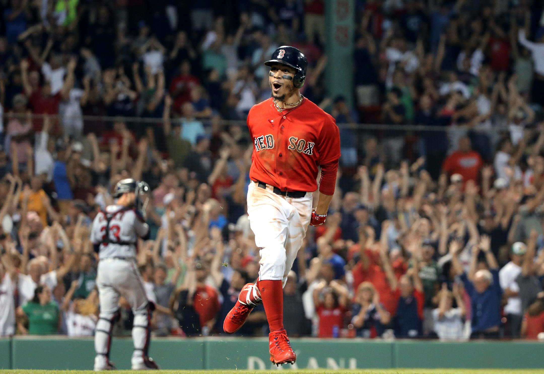Mookie Betts celebrates his walk-off solo home run as he rounds the bases in the 10th inning Frida at Fenway Park