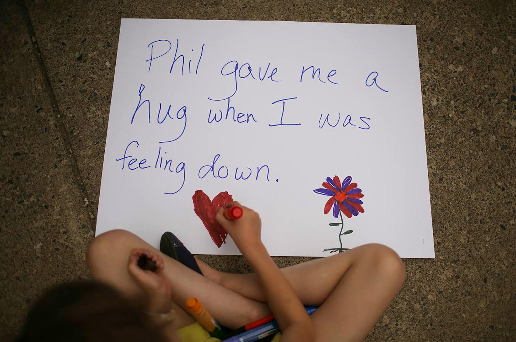 A student at J.J. Hill Montessori Magnet School made a poster before the vigil for Philando Castile began Thursday evening.