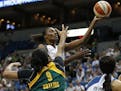Minnesota Lynx center Sylvia Fowles, center, shoots in front of Seattle Storm center Markeisha Gatling (9) during the first half of a WNBA basketball 