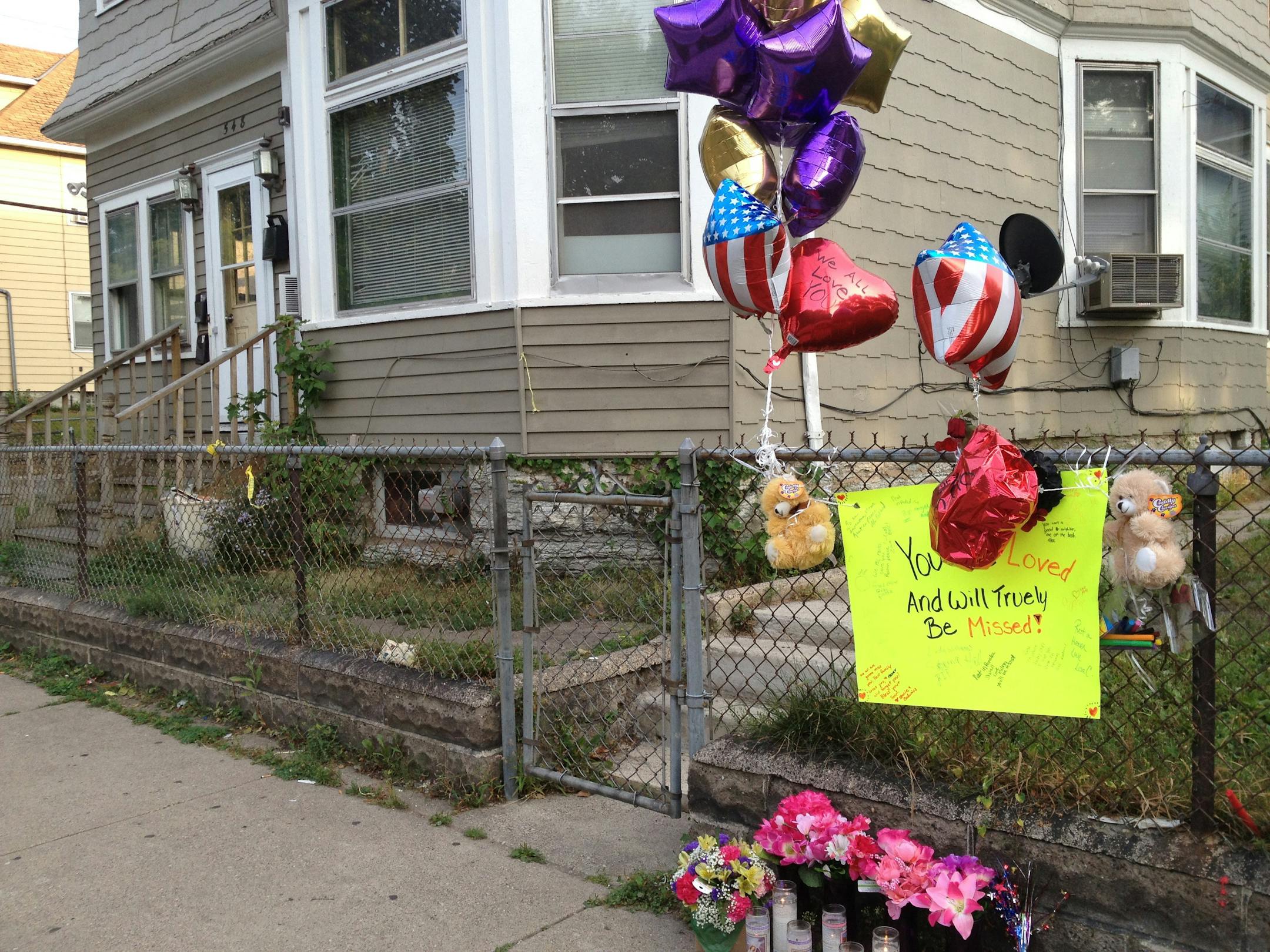 A memorial of candles and balloons was left at a fence in front of the home on the 500 block of Minnehaha Avenue E. in St. Paul where Sherell Montrese Craighead, 30, was found dead.