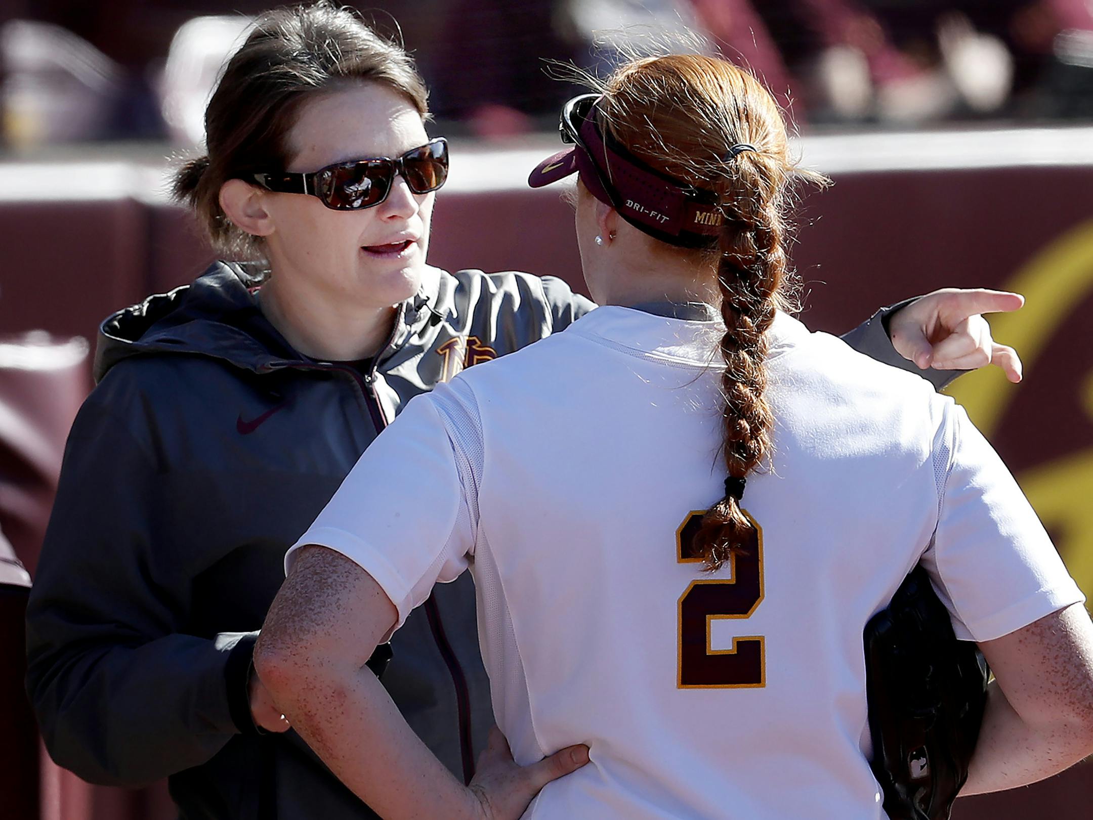 Former Gophers head coach Jessica Allister spoke with Dani Wagner (2) between innings of a game earlier this season.