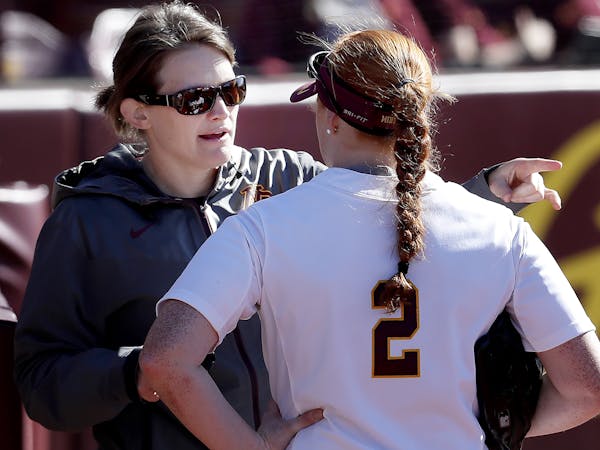 Former Gophers head coach Jessica Allister spoke with Dani Wagner (2) between innings of a game earlier this season.