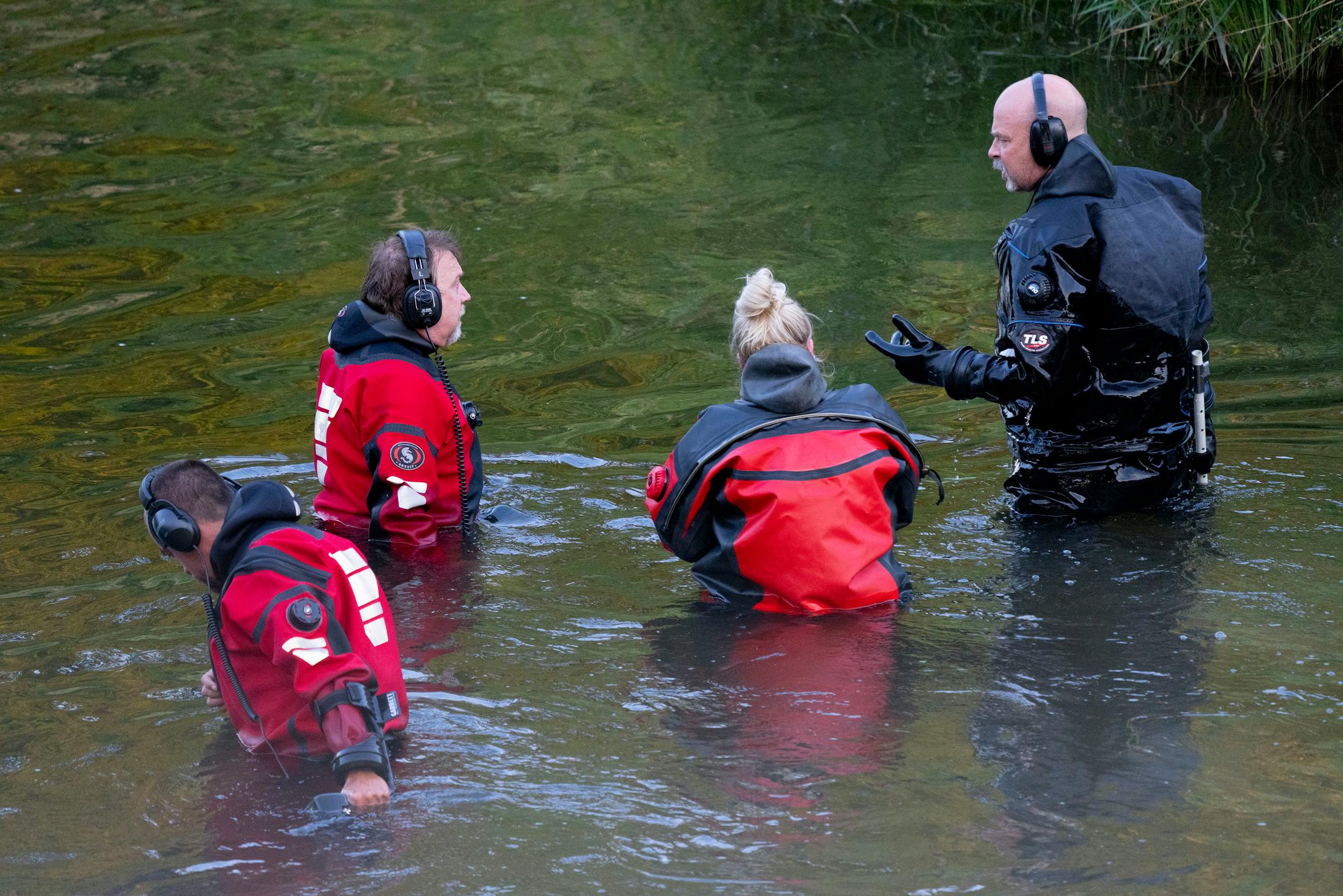 Water Recovery authorities comb the Apple River with metal detectors after five people were stabbed while tubing down the river Saturday, July 30, 2022 in Somerset, WI.   ]