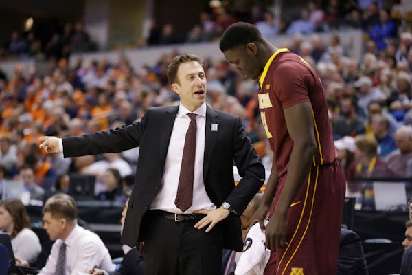 Minnesota's head coach Richard Pitino talks to Gaston Diedhiou (41) in the second half of an NCAA college basketball game against Illinois at the Big 