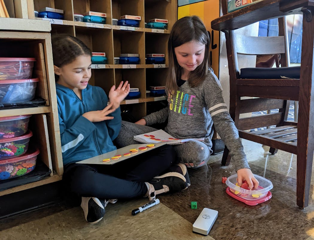 Aubrey Daniels, left, and Isabelle Peterson worked on multiplication using toy pepperoni slices in Janet Husby's third-grade class at Churchill Elementary School in Cloquet last week.