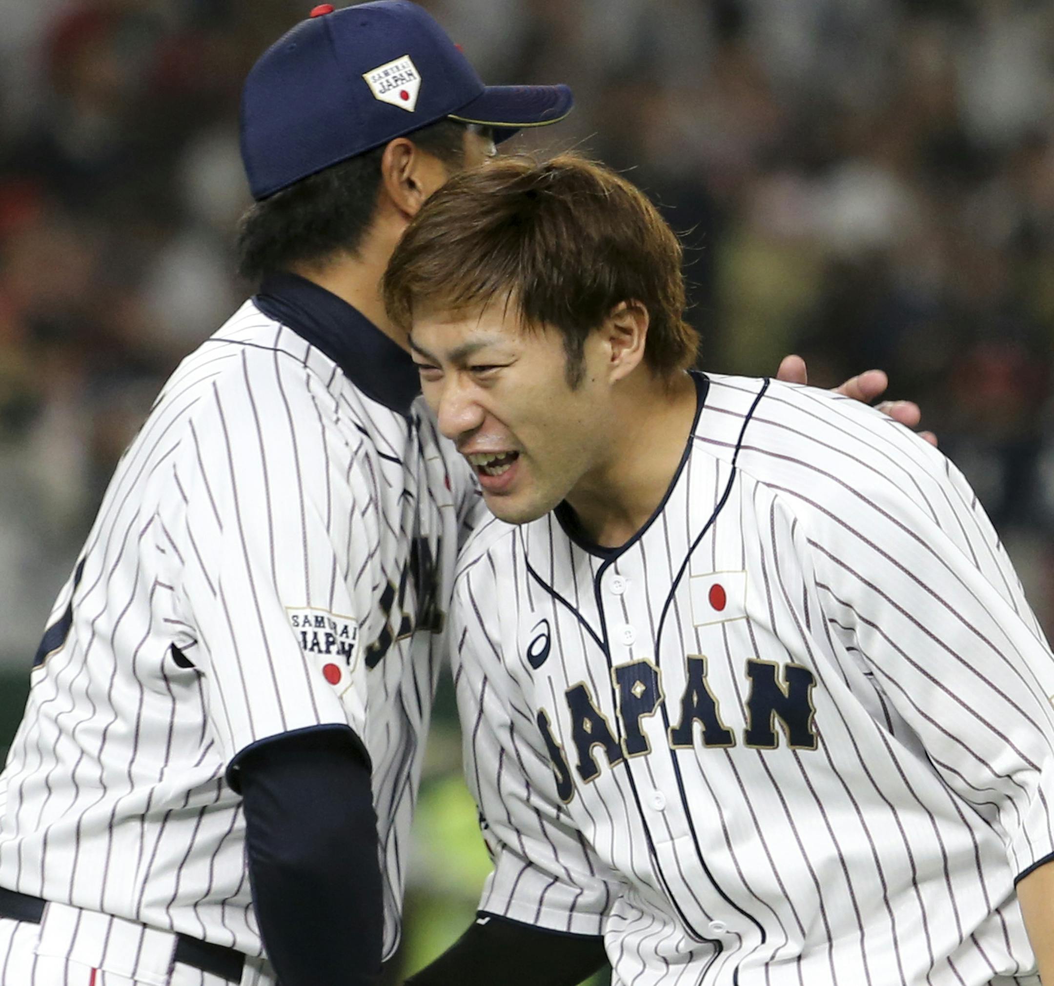 All Japan's Yuki Yanagita, right, is celebrated by head coach Makoto Kaneko after hitting a walk-off two-run home-run off MLB All-Star closer Kirby Yates of the San Diego Padres to win Game 1 of their All-Stars Series baseball at Tokyo Dome in Tokyo, Friday, Nov. 9, 2018. Japan's national team beat Major League's team 7-6. (AP Photo/Toru Takahashi)