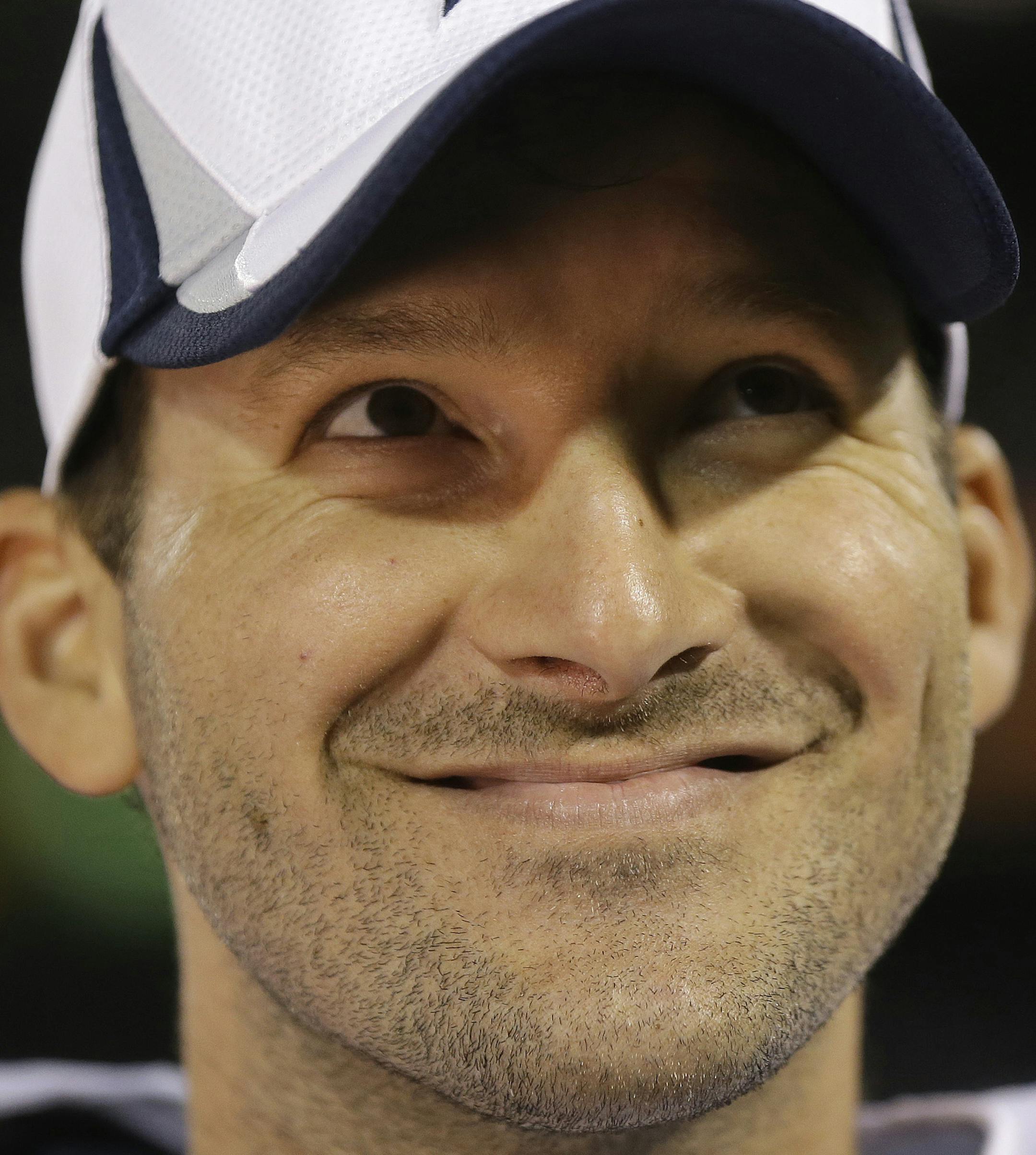 Dallas Cowboys quarterback Tony Romo smiles on the sideline during the fourth quarter of an NFL preseason football game against the Oakland Raiders in Oakland, Calif., Friday, Aug. 9, 2013. (AP Photo/Marcio Jose Sanchez) ORG XMIT: OAS