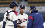 Minnesota Twins pitcher Jose Berrios, center, is removed by manager Paul Molitor during the eighth inning against the Colorado Rockies in the second g