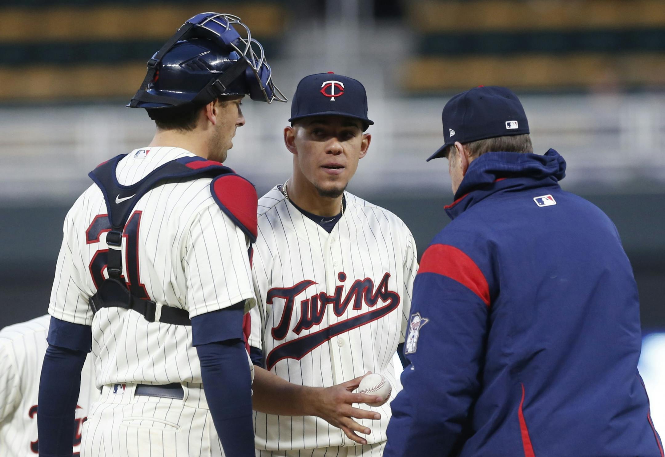 Minnesota Twins pitcher Jose Berrios, center, is removed by manager Paul Molitor during the eighth inning against the Colorado Rockies in the second game of a baseball doubleheader Thursday, May 18, 2017, in Minneapolis. The Twins won 2-0, with Berrios getting the win.