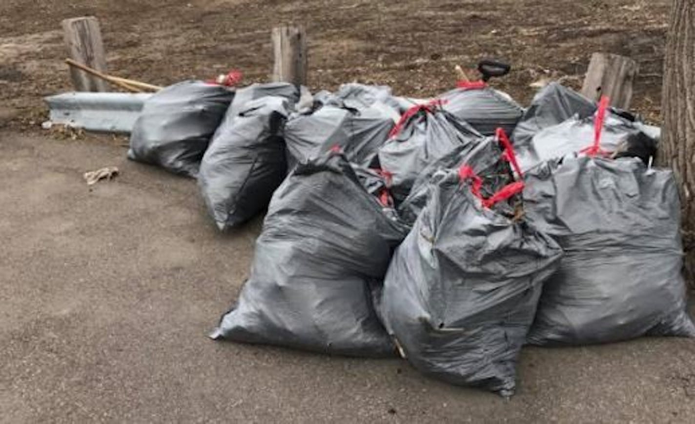 Volunteers, frustrated by a lack of government action, cleaned up dozens of bags of trash at 10th and Wacouta streets on the edge of downtown St. Paul.