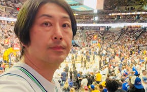 Mitsuaki Ohno takes a selfie during the Timberwolves' Game 7 win over the reigning champion Denver Nuggets.