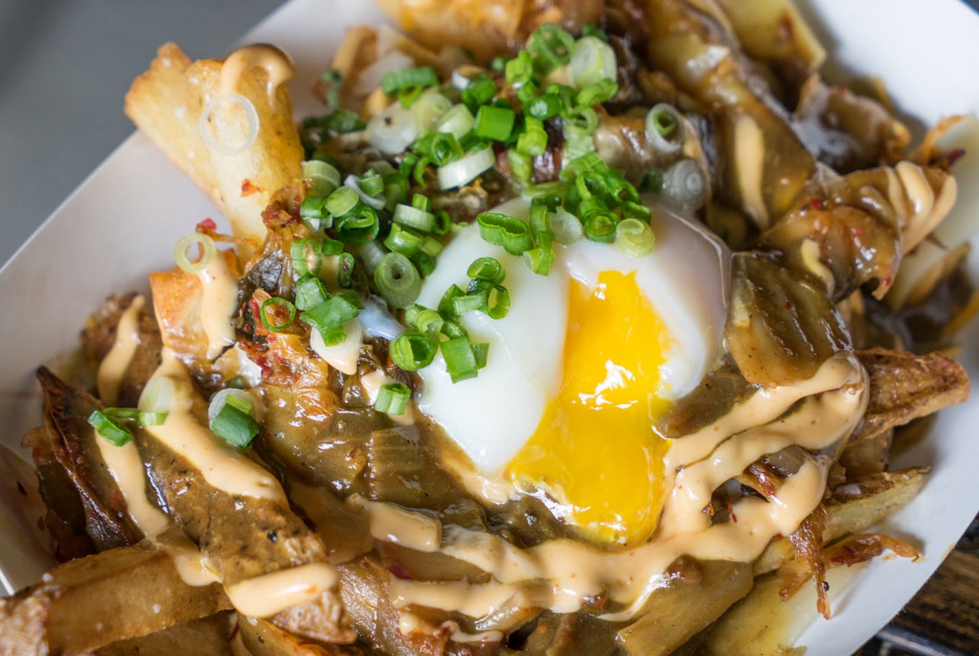 Kimchi 'n' Curry Poutine: Braised pork and potatoes smothered with curry gravy and cheddar cheese, then topped with kimchi and a poached egg. Find it at The Rabbit Hole located at Taste of Midtown Global Market at the International Bazaar, east wall.
Available Sept. 2 – 7 only.