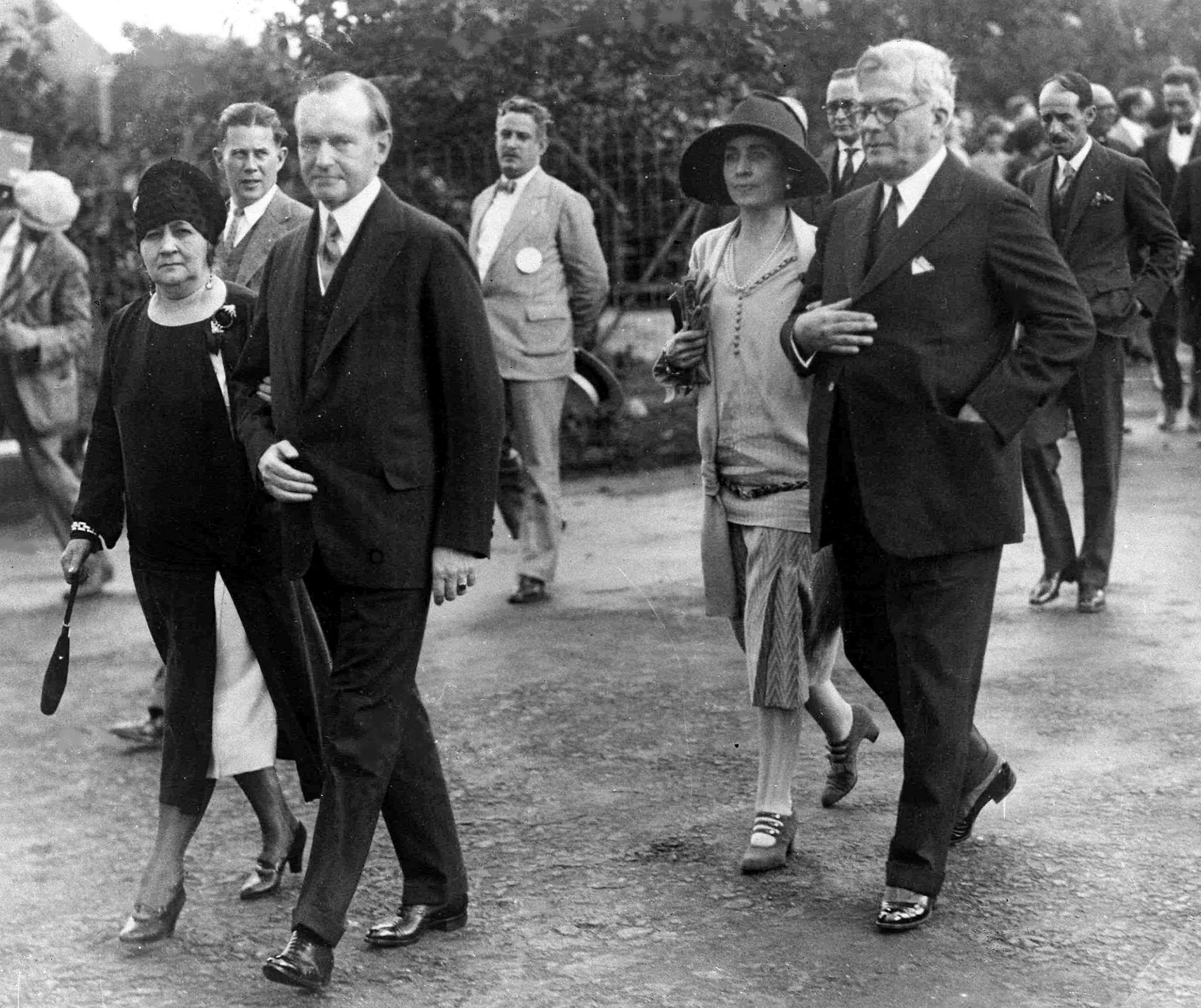 U.S. President Calvin Coolidge, second from left, and his wife, first lady Grace Coolidge, third from left, are shown with the President of Cuba General Gerardo Machado y Morales, right, and his wife, Elvira Machado, left, walk on the estate of President Machado in Havana, Cuba, Jan. 19, 1928. (AP Photo) Note: Coolidge and Morales are walking with each other's spouses. ORG XMIT: APHSL58714