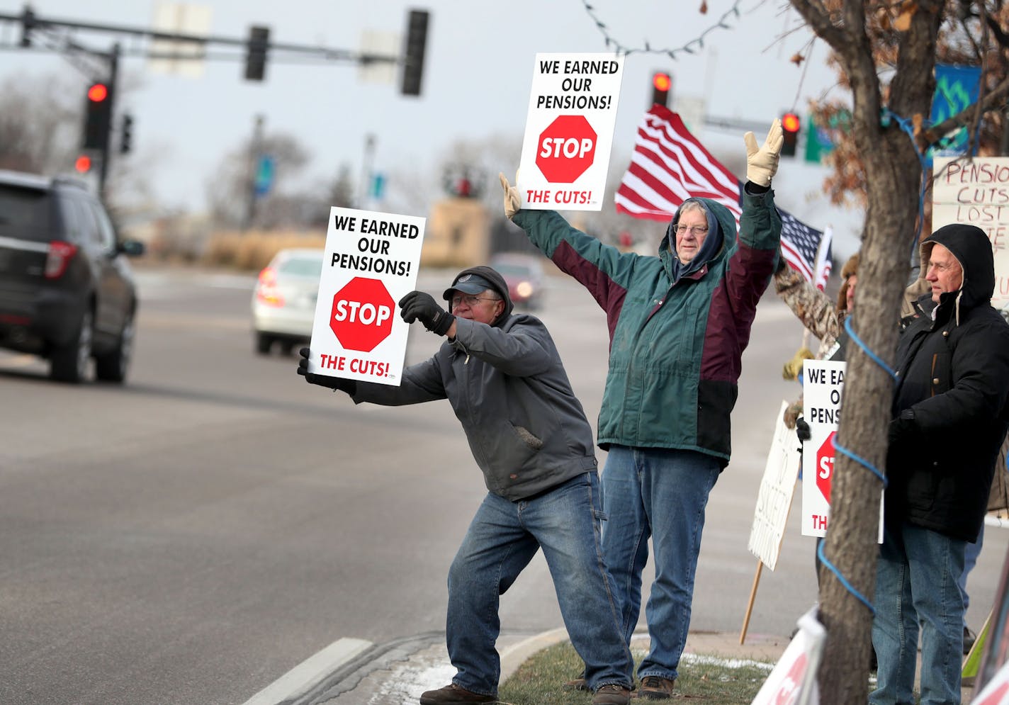 Teamsters and supporters gathered outside U.S. Rep. John Kline's office to protest Kline's new bill that could slash pensions Saturday, Dec. 10, 2016, in Burnsville, MN. Here, Dave Kalk, left to right, and Phil Draayer, both of Owatonna and members of local 160, attempt to catch the eye of passing motorists. Kalk said he worked for 37 years before retiring and if the legislation passes his pension could be slashed by 50 percent.]
(DAVID JOLES/STARTRIBUNE)djoles@startribune.com Hundreds of people