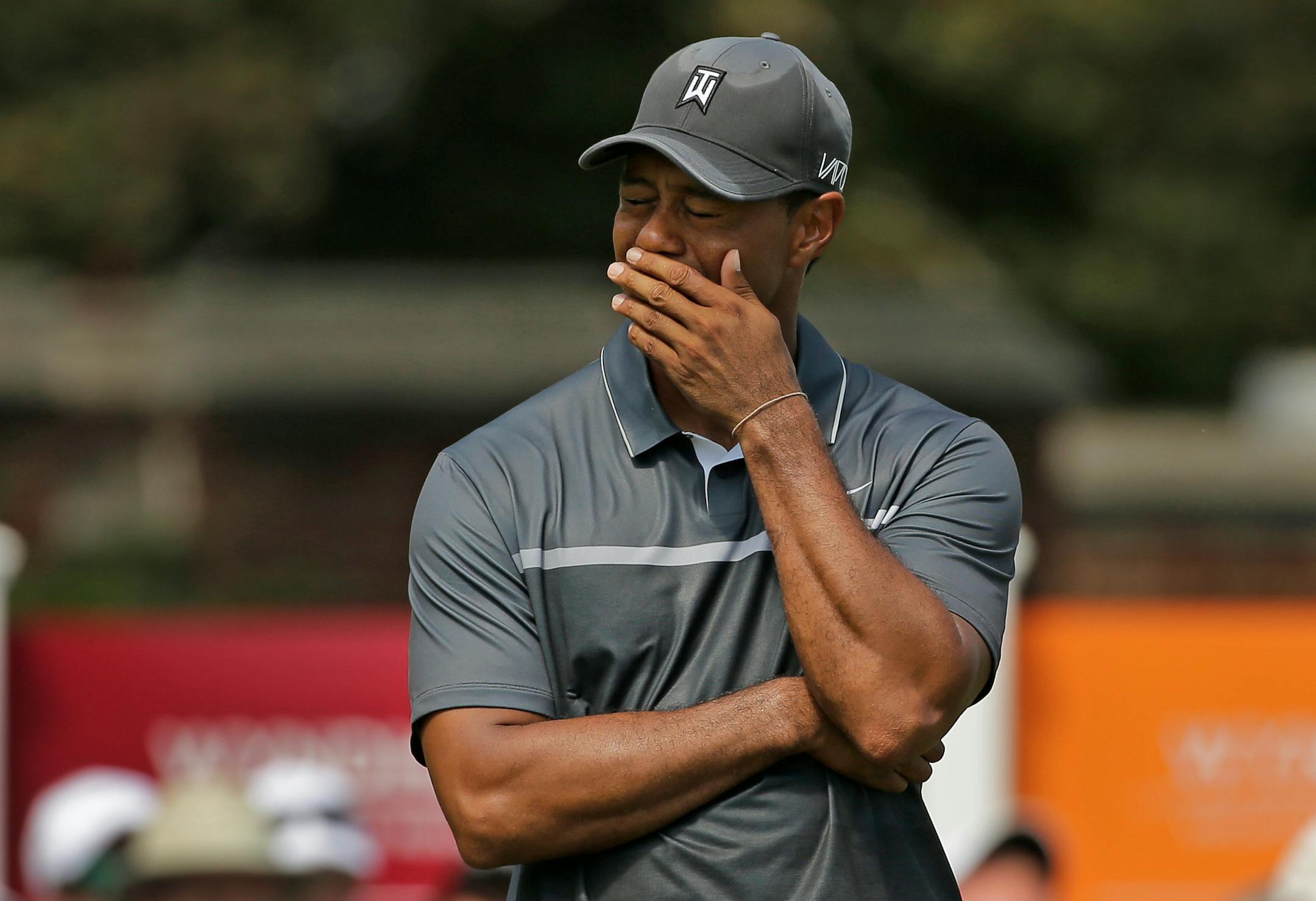 In this Aug. 21, 2015, file photo, Tiger Woods reacted after missing a putt on the ninth hole during the second round of the Wyndham Championship golf tournament. Woods painted a bleak picture Tuesday on when he can return to golf or even get back to doing anything more than just walking.