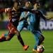 Angelo Rodriguez, left, of Colombia's Tolima, fights for the ball with Jorge Flores of Bolivia's Bolivar during a Copa Sudamericana soccer match in La
