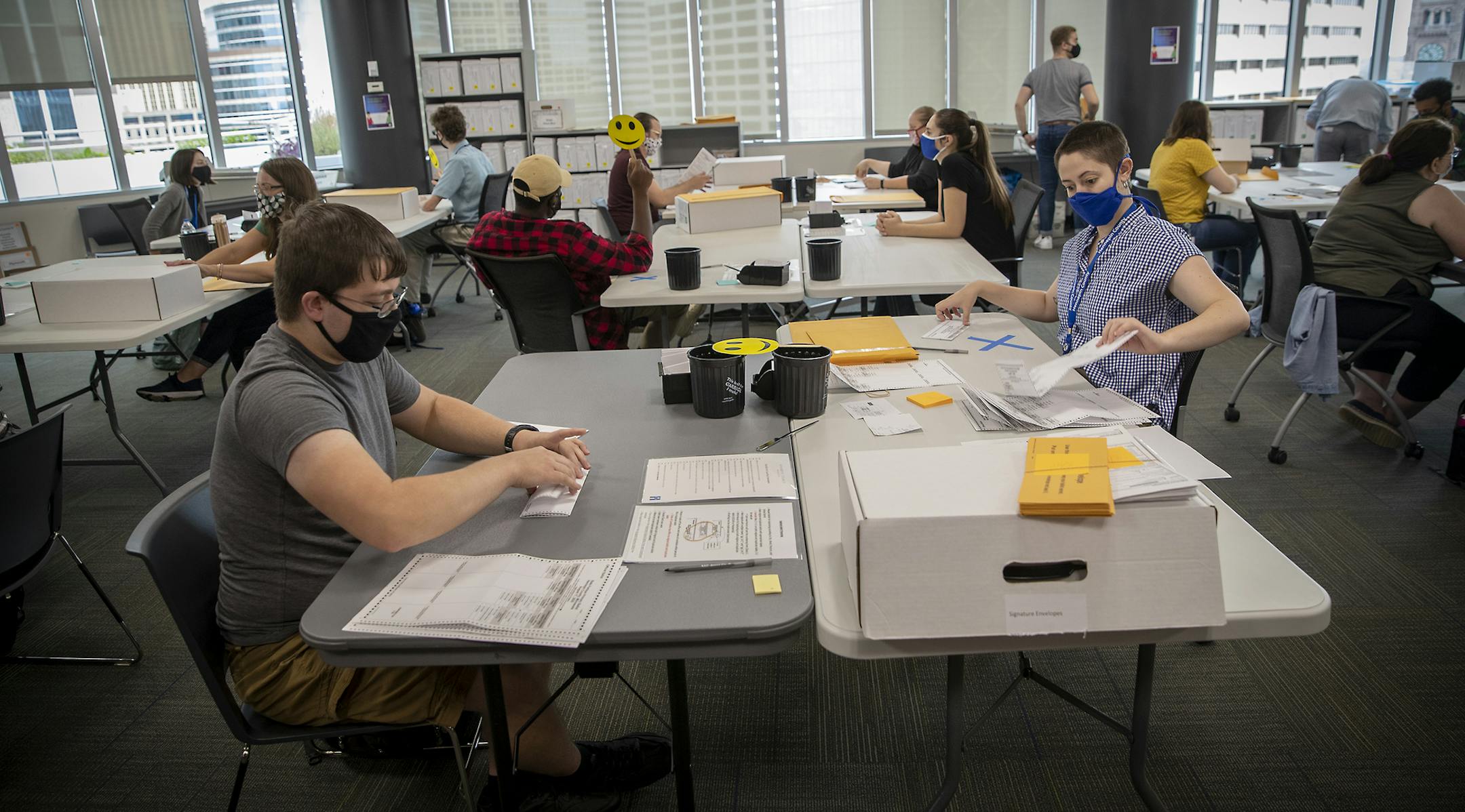 Hennepin County election workers Timonthy Hart, left, and Olivia Reyes, right, counted absentee ballots for the primary election, Monday, August 10, 2020 in downtown Minneapolis, MN. ] ELIZABETH FLORES • liz.flores@startribune.com