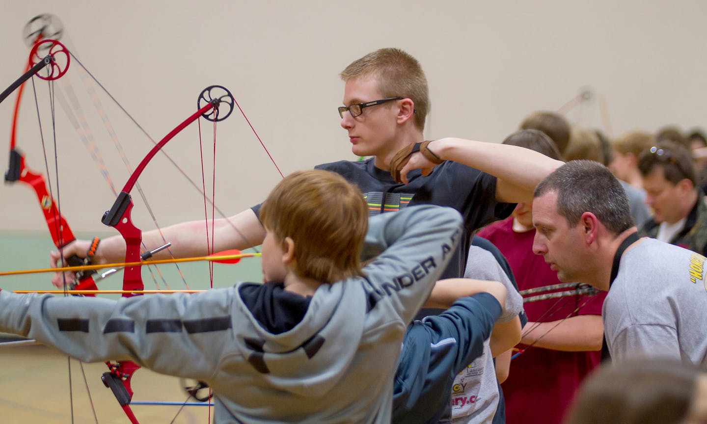 Logan Greer (with glasses), an eighth-grader in New Prague, is a 2012 NASP (National Archery in the Schools Program) national champion at the elementary level. He was 15th overall and second in the middle school boys division at the 2014 Minnesota state tournament and will be making his third consecutive trip to the national tournament in Louisville in May. Photo by Mark Hvidsten