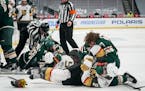 Wild rookie Kirill Kaprizov (97) and Vegas Golden Knights defenseman Zach Whitecloud (2) fought on the ice in the first period Wednesday night.
