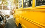 Closeup of classic yellow school bus parked on the street. istock