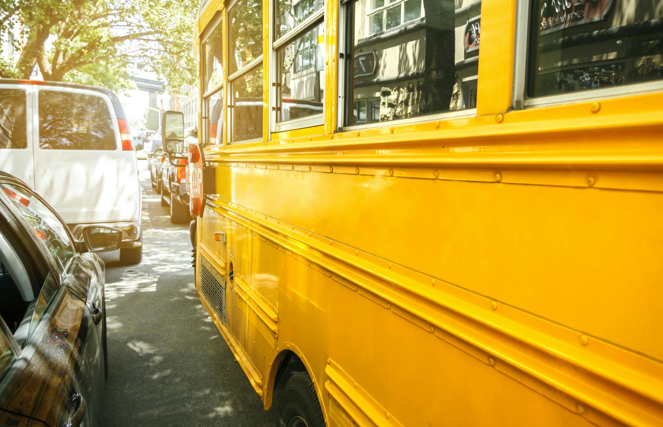 Closeup of classic yellow school bus parked on the street. istock