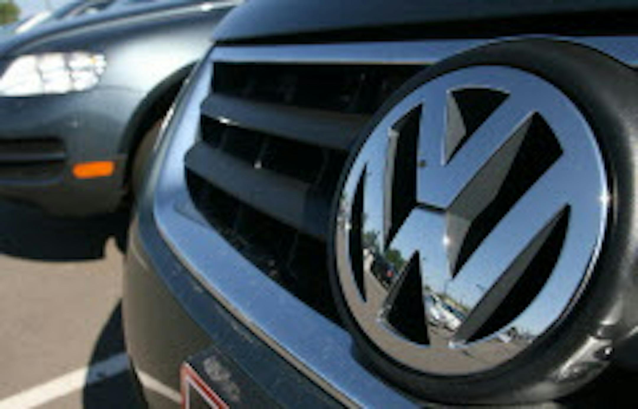 FILE - In this Wednesday, July 26, 2006, file photo, a Volkswagen reflects a Volkswagen dealership in the west Denver suburb of Lakewood, Colo. U.S. safety regulators won't be pushing for a recall of thousands of Volkswagens that have the same electric fuses as a model that was recalled. (AP Photo/David Zalubowski, File)