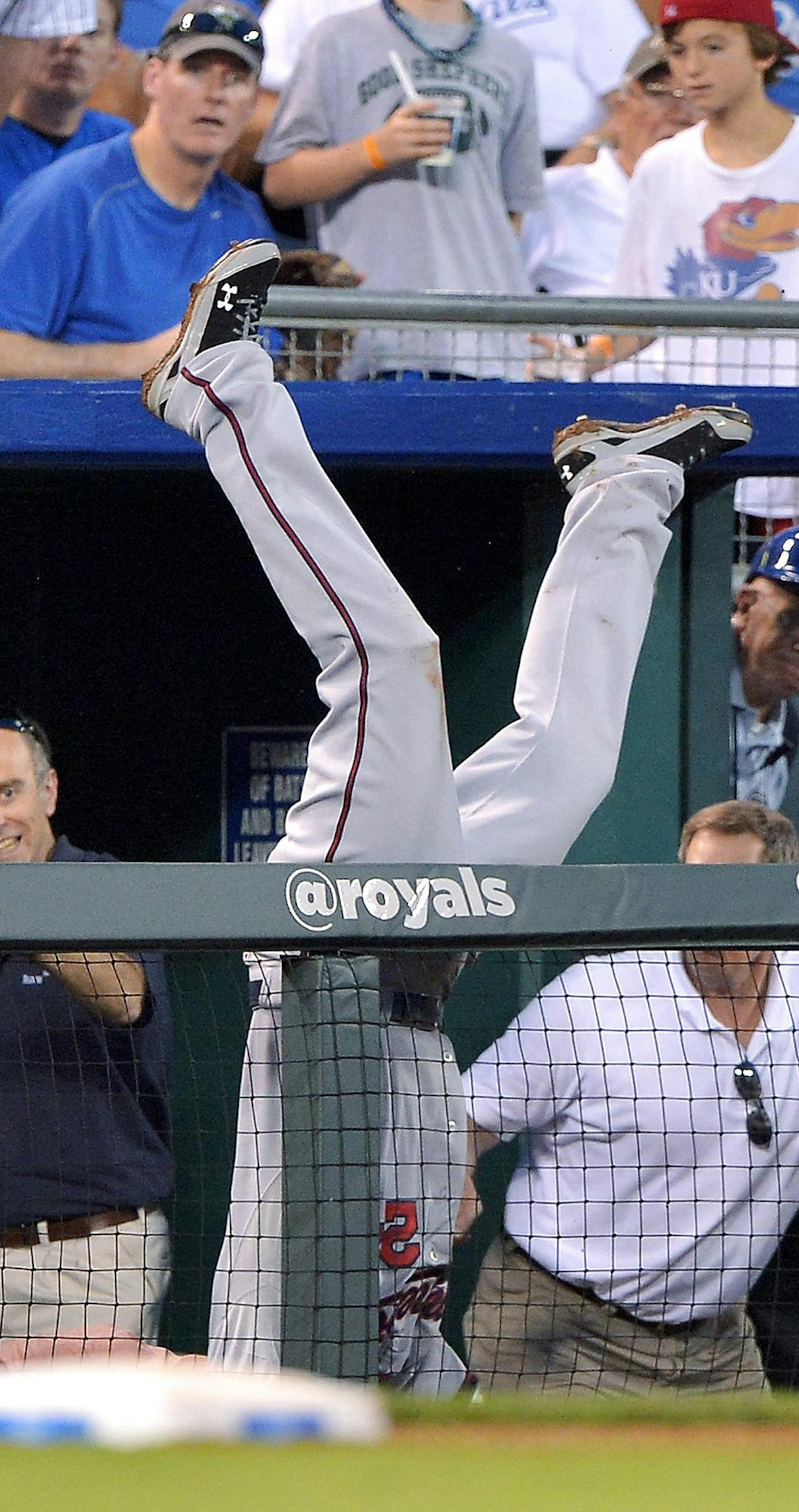 Minnesota Twins third baseman Trevor Plouffe (24) makes the catch on a foul ball hit by Kansas City Royals' Alex Gordon, but ends up in the dugout suites, for the third out of the fifth inning at Kauffman Stadium in Kansas City, Missouri, Monday, August 5, 2013. (John Sleezer/Kansas City Star/MCT)