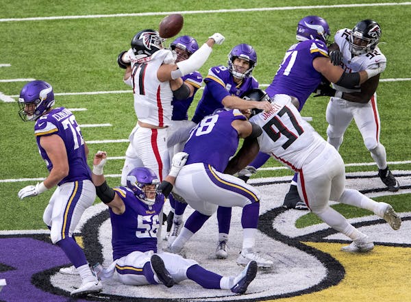 Jacob Tuioti-Mariner (91) of the Atlanta Falcons deflected a pass by Minnesota Vikings quarterback Kirk Cousins (8) that was intercepted in the second