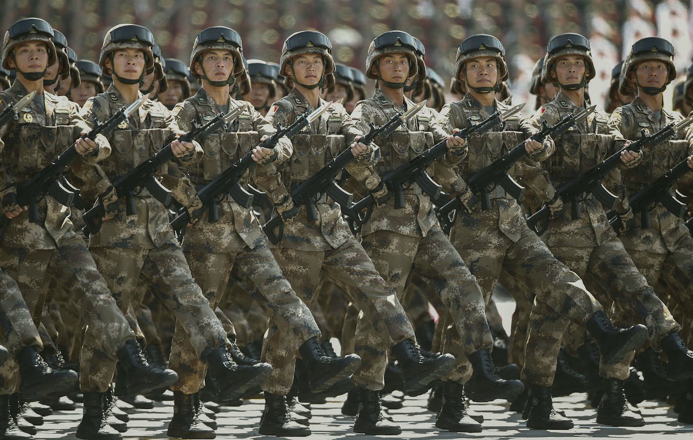 Chinese soldiers march during a parade commemorating the 70th anniversary of Japan's surrender during World War II in front of Tiananmen Gate in Beijing, Thursday, Sept. 3, 2015. The spectacle involved more than 12,000 troops, 500 pieces of military hardware and 200 aircraft of various types, representing what military officials say is the Chinese military's most cutting-edge technology. (Rolex Dela Pena/Pool Photo via AP) ORG XMIT: MIN2015090308565011