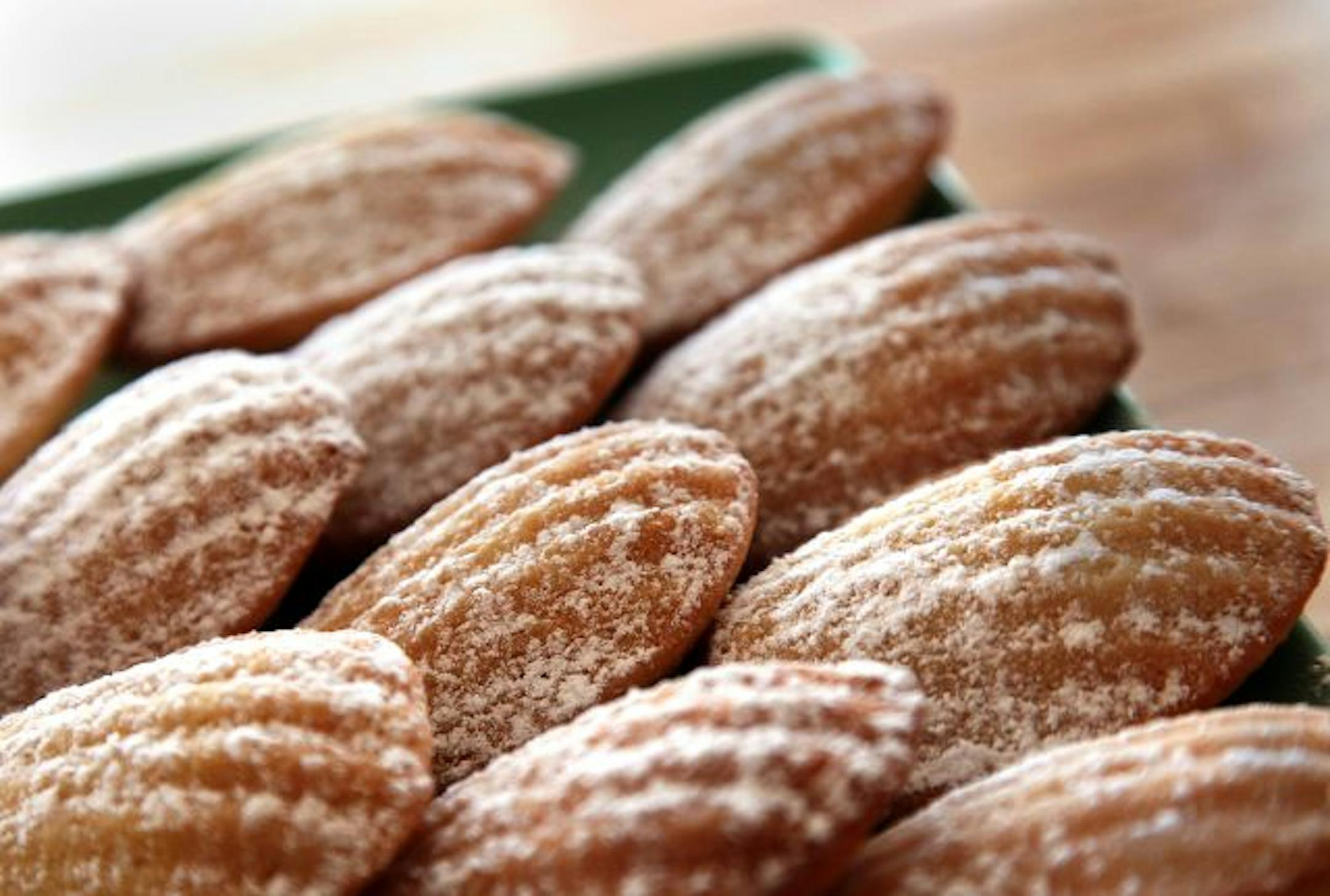 Lemony madeleines with a dusting of powdered sugar are a memorable and easy-to-make dessert.