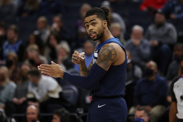 Minnesota Timberwolves' D'Angelo Russell (0) talks to teammates before a play during the first half of an NBA basketball game against the Orlando Magi
