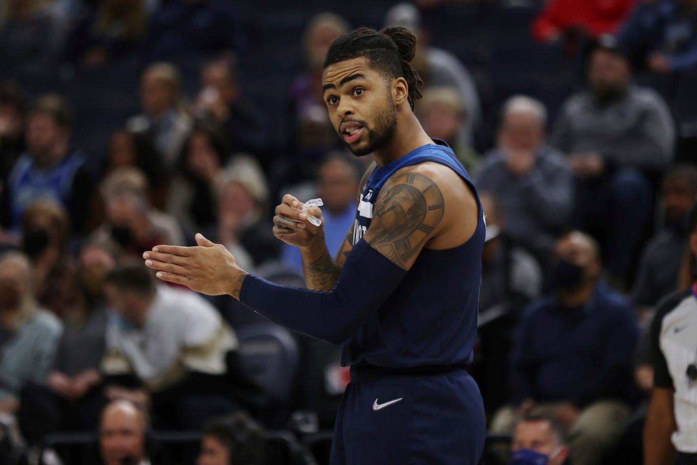 Minnesota Timberwolves' D'Angelo Russell (0) talks to teammates before a play during the first half of an NBA basketball game against the Orlando Magic, Monday, Nov. 1, 2021, in Minneapolis. Orlando won 115-97. (AP Photo/Stacy Bengs)