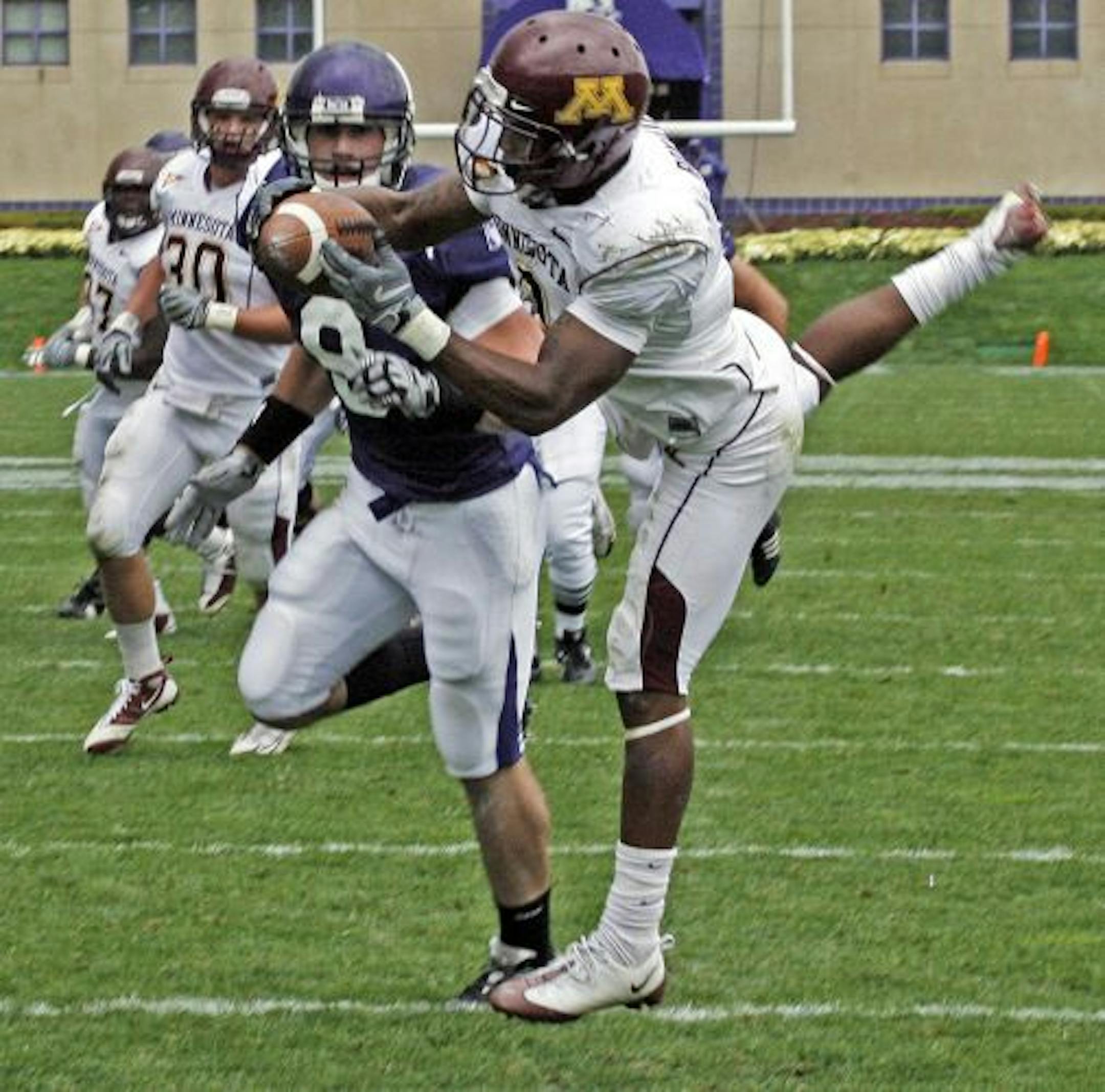 Gophers defender Kim Royston intercepted this first half pass stepping in front of Northwestern's Demetrius Fields (8) for the interception which stopped a Northwestern drive near the goal line.