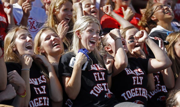 Students at Minnehaha Academy celebrated with a "roller coaster" wave as the homecoming festivities came to an end in the football stands.] Minnehaha 