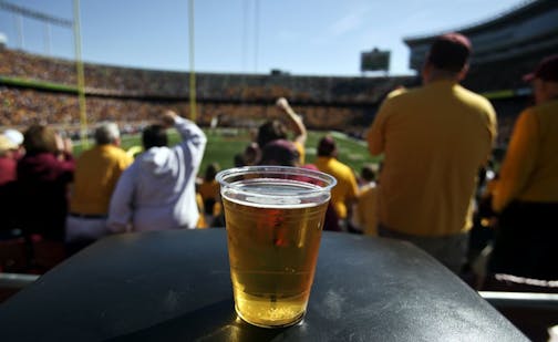 A beer sits atop a garbage can as Gopher fans cheer a long first quarter play against New Hampshire Saturday, Sept. 8, 2012, at TCF Bank Stadium in Minneapolis, MN.