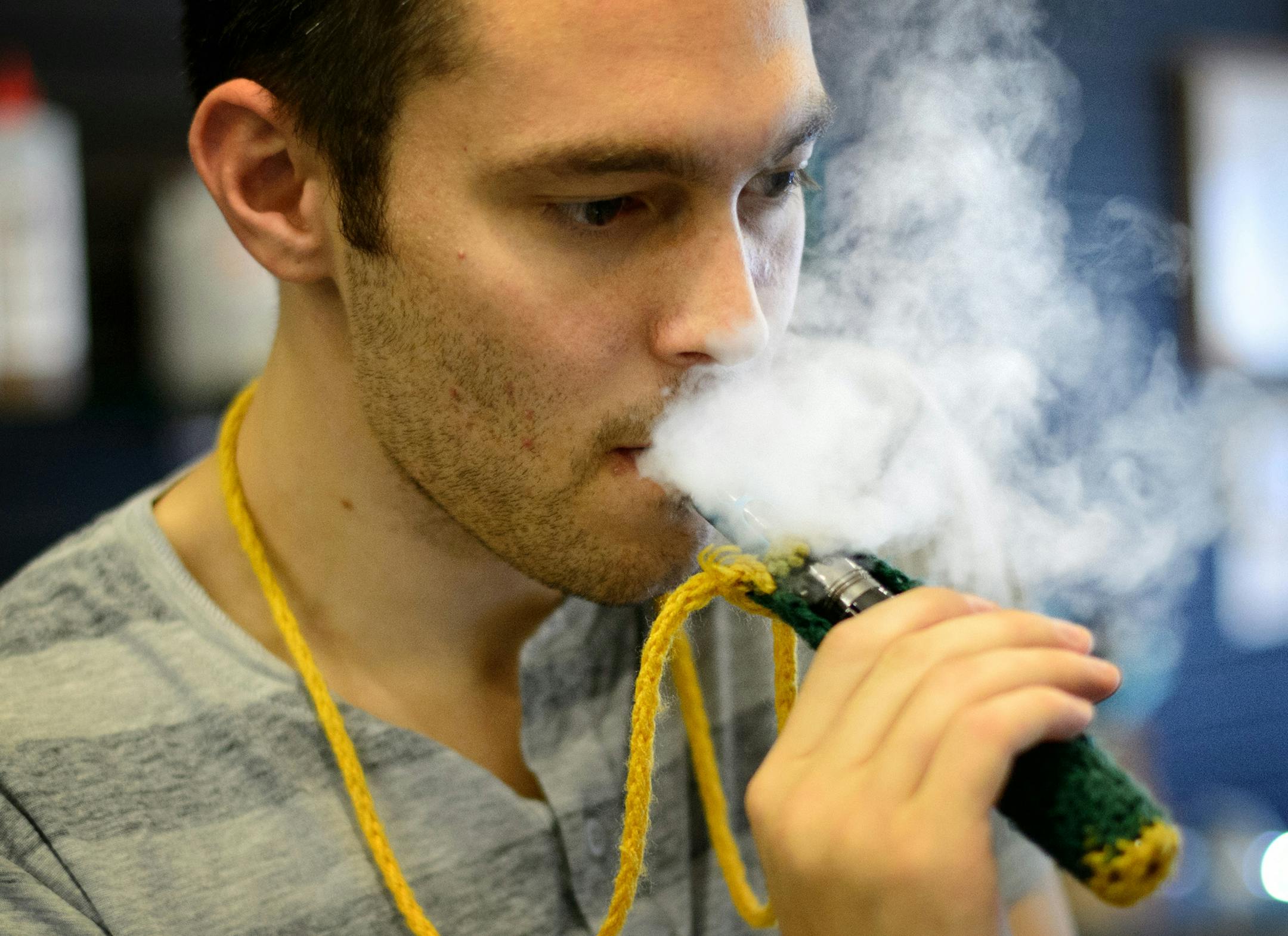 E-cigarettes emit a mild vapor that dissipates quickly. Uptown Vapor Shop employee Ryan Comings puffed as he helped a customer. Tuesday, September 10, 2013 ] GLEN STUBBE * gstubbe@startribune.com