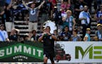 Minnesota United FC forward Danny Cruz (8) sprayed water in the air after celebrating with United fans after a win in July.