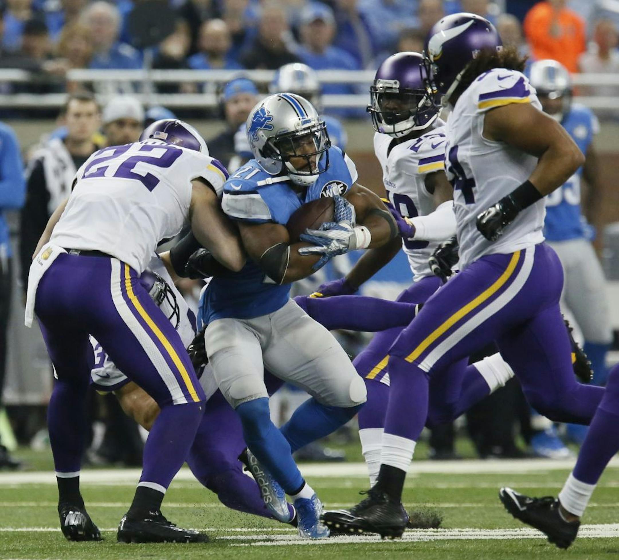 Detroit Lions running back Ameer Abdullah (21) is tackled by Minnesota Vikings free safety Harrison Smith (22) during the first half of an NFL football game, Sunday, Oct. 25, 2015, in Detroit.