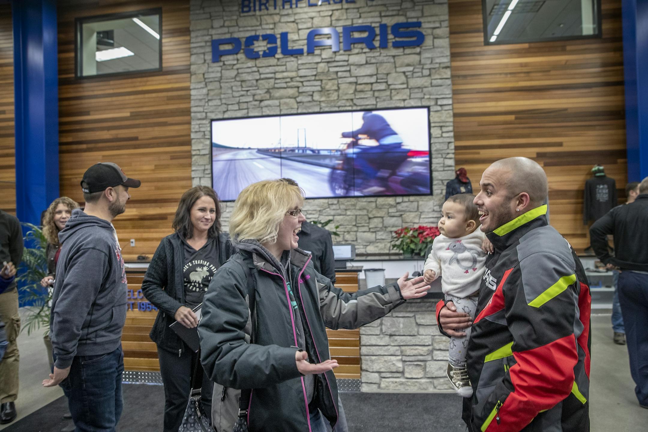 Harley Lebrón, with his 8-month-old Gia, was greeted by a line of community members during a community welcome party and open house that Polaris hosted for families from Puerto Rico and the community at the Polaris manufacturing plant, Monday, February 17, 2020 in Roseau, MN.