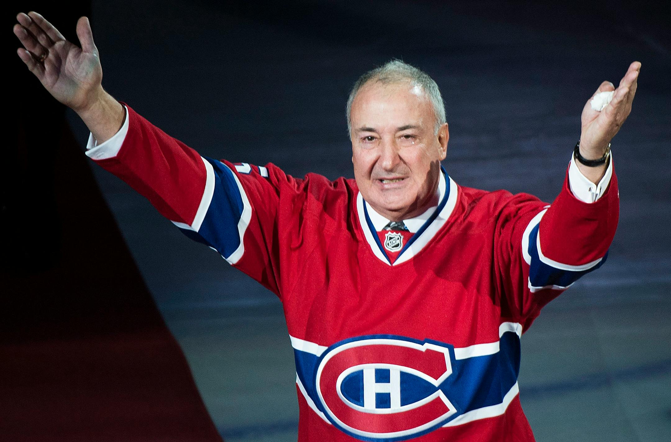 Former Montreal Canadien Guy Lapointe salutes the crowd as his number is raised during a retirement ceremony prior to an NHL hockey game between the Canadiens and the Minnesota Wild in Montreal, Saturday, Nov. 8, 2014. (AP Photo/The Canadian Press, Graham Hughes)