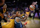 Minnesota Lynx guard Seimone Augustus (33) passed the ball to guard Lindsay Whalen (13) as she fell to the floor while being defended by Los Angeles S