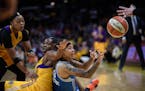 Minnesota Lynx guard Seimone Augustus (33) passed the ball to guard Lindsay Whalen (13) as she fell to the floor while being defended by Los Angeles S