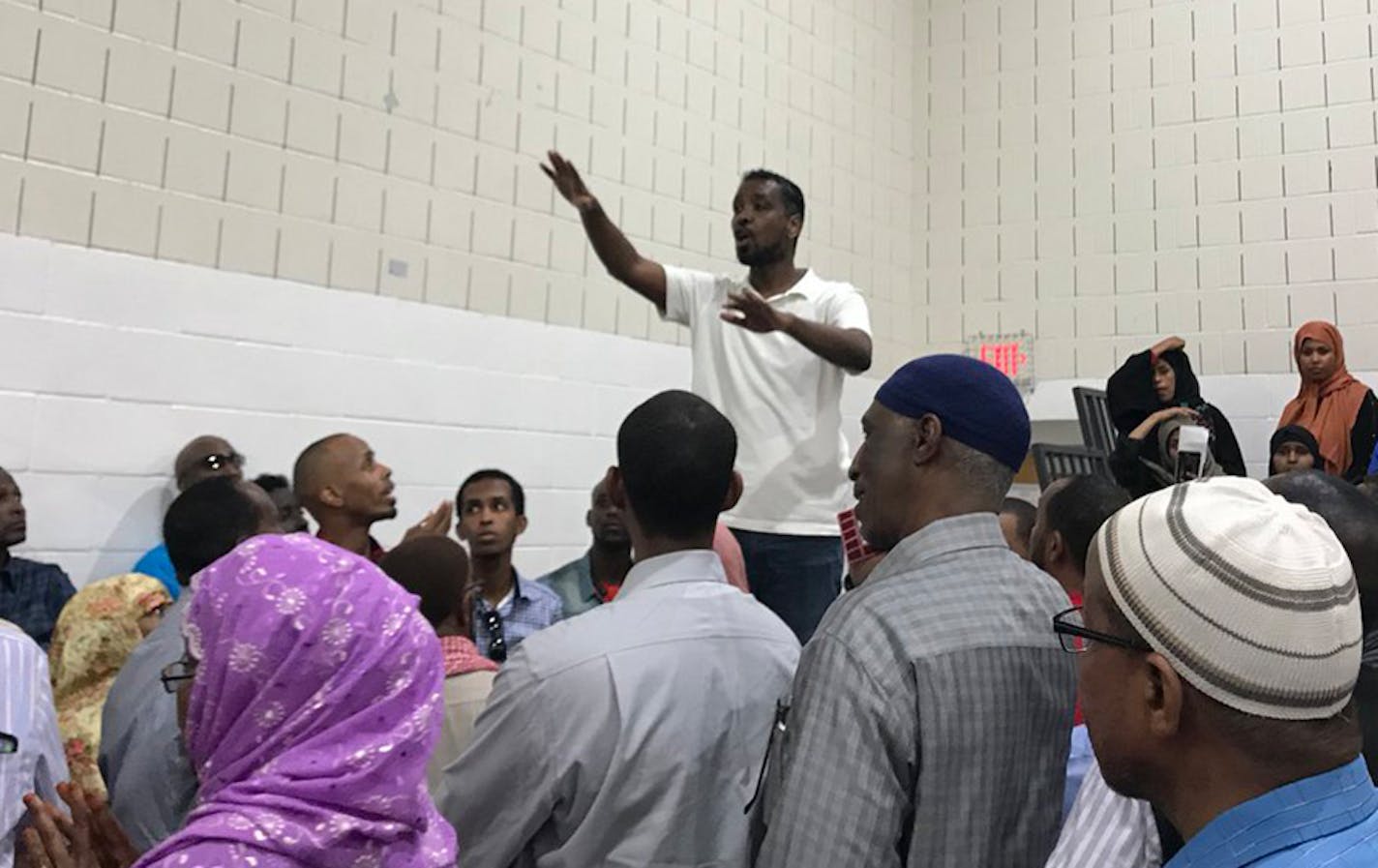 Council Member Abdi Warsame faced a chaotic scene at times Friday night inside the gym of the Brian Coyle Community Center.