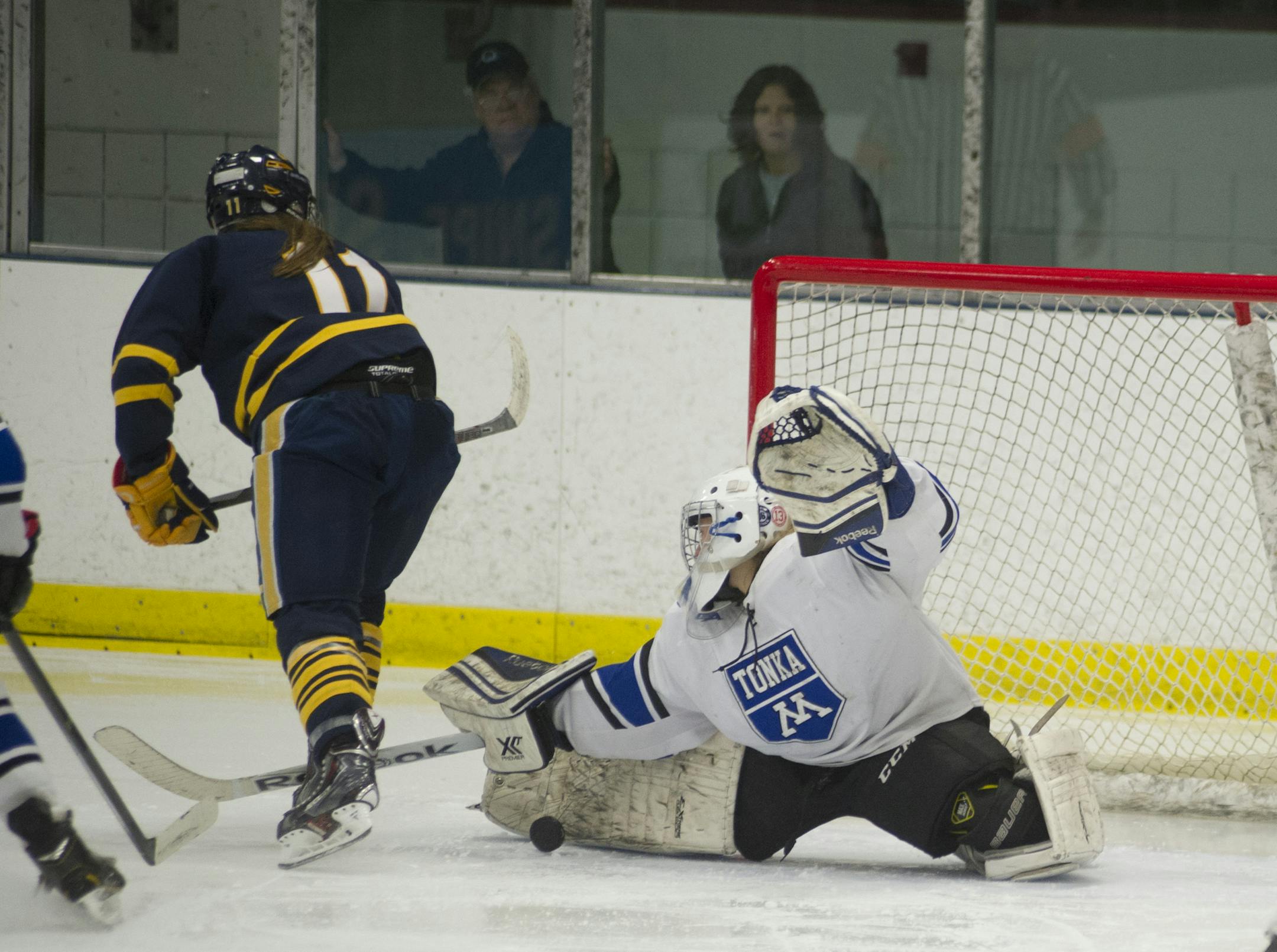 Minnetonka goalie Taty Delaittre made a save against Wayzata&#x2019;s Izzy Shannon during the third period of a 3-2 overtime victory Friday at Parade Ice Garden. (Matthew Hintz, special to the Star Tribune)