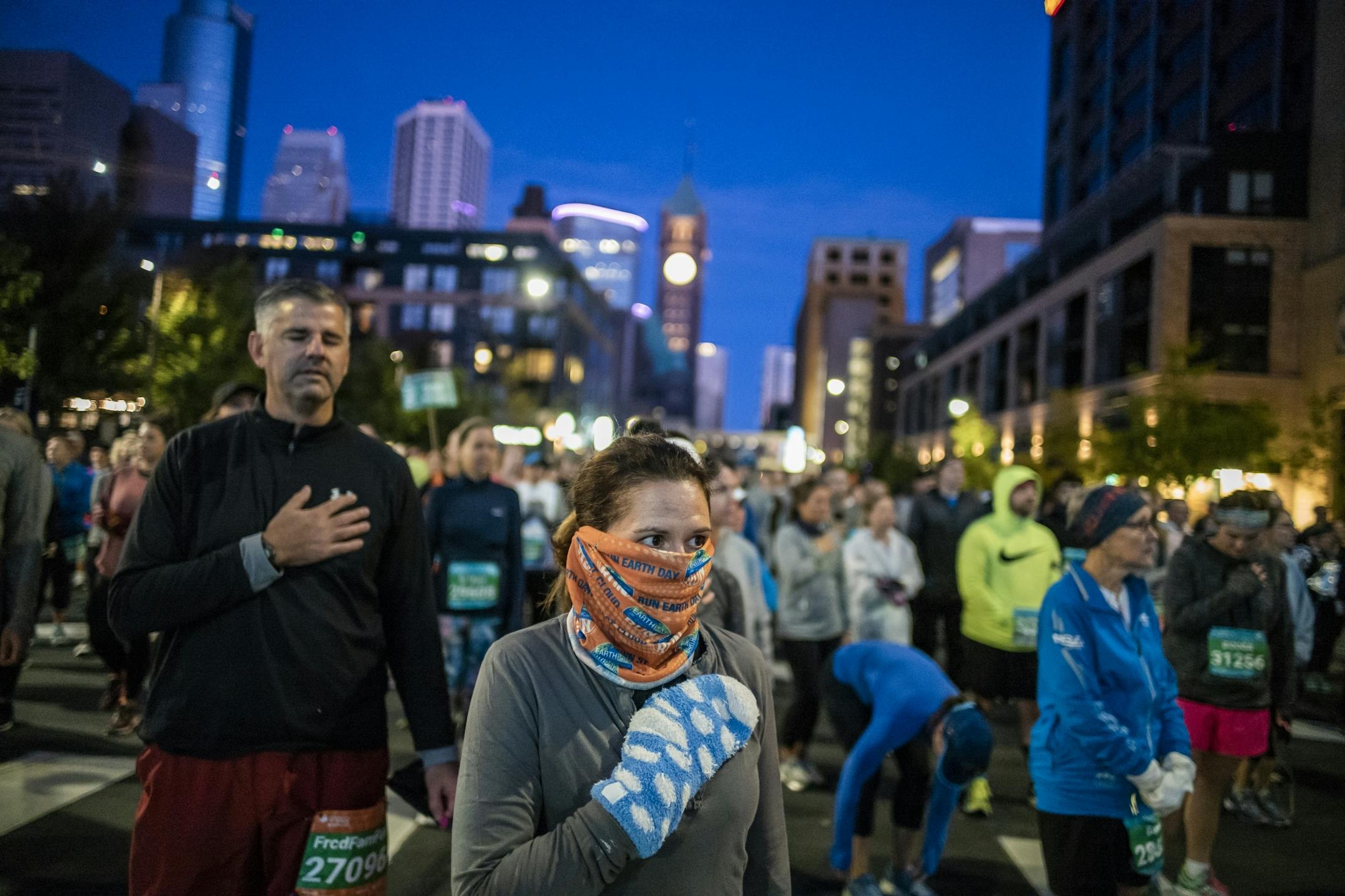 Jennifer Bunkers stands for the National Anthem before the 10-mile race
