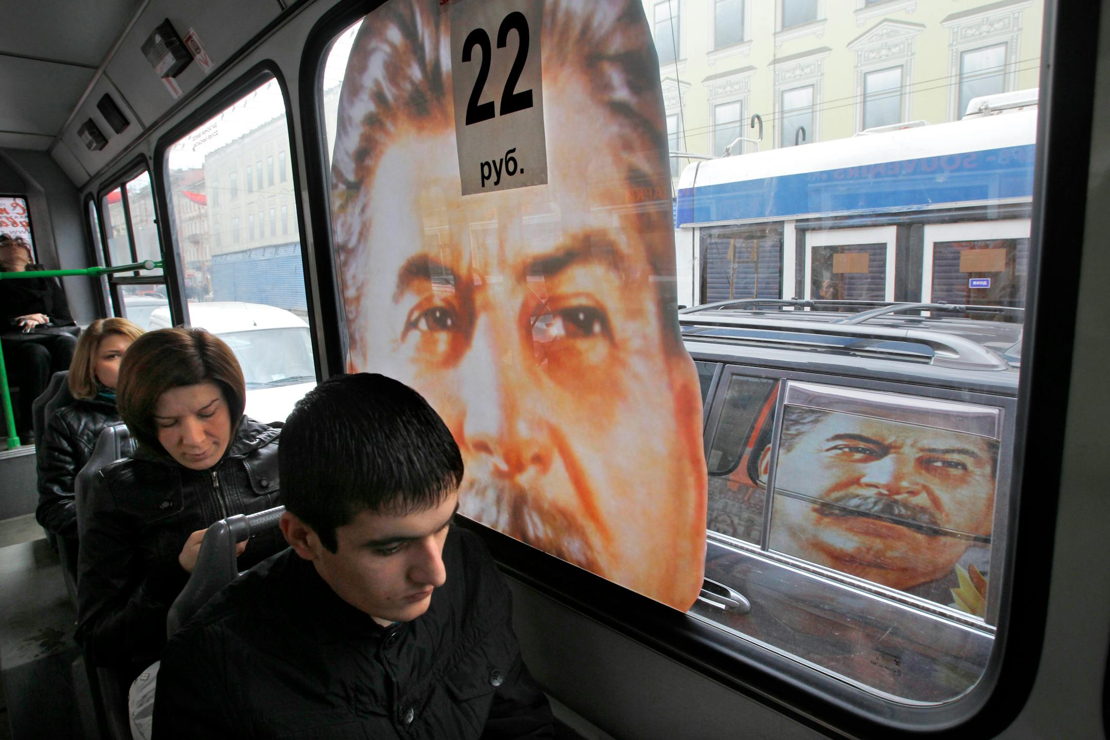 2010 photo: Commuters ride aboard a bus with a portrait of Soviet dictator Josef Stalin, in St. Petersburg, Russia.