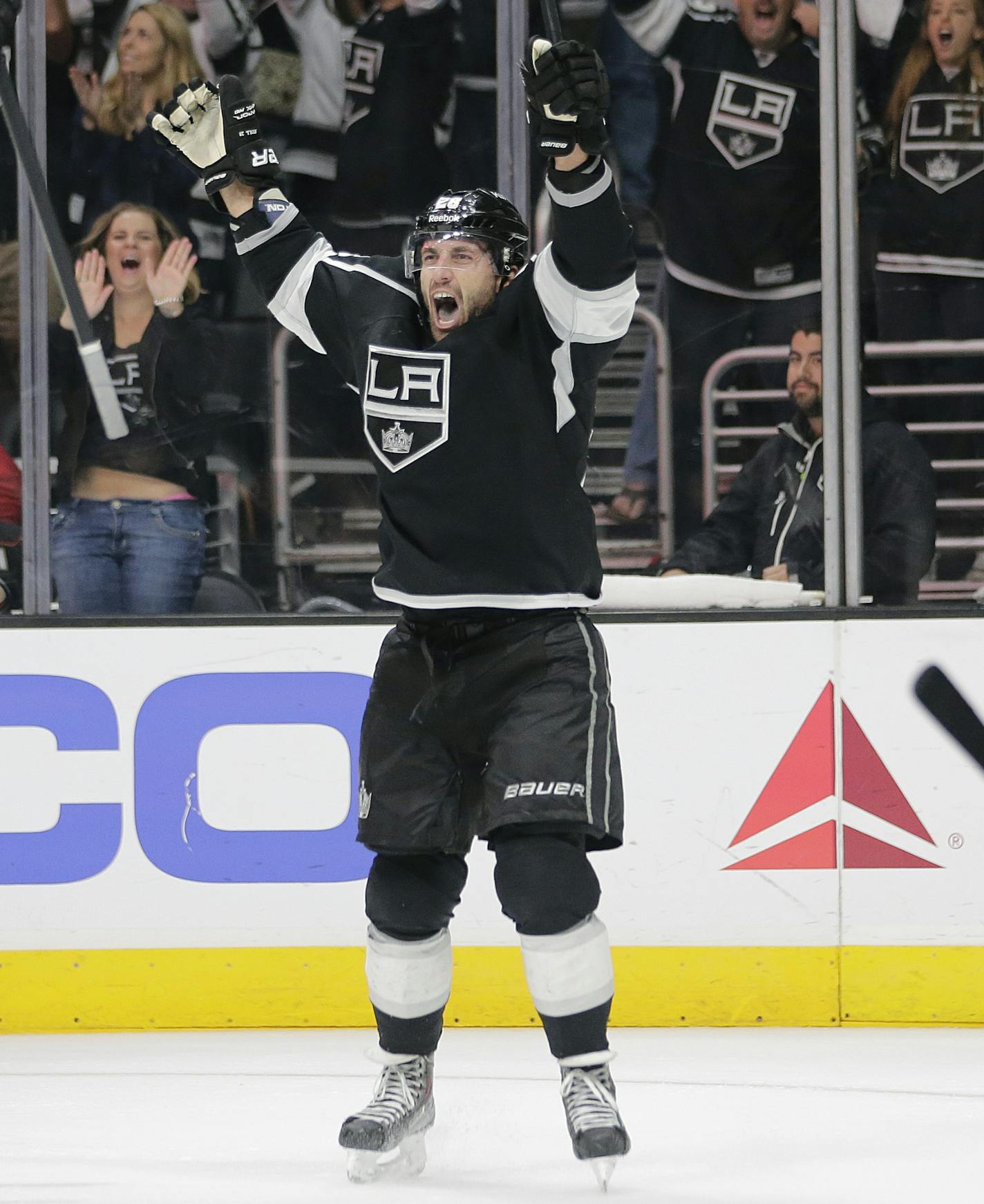 Los Angeles Kings' Jarret Stoll, right, celebrates his goal with Drew Doughty in overtime of an NHL hockey game against the Anaheim Ducks Saturday, Nov. 15, 2014, in Los Angeles. The Kings won 3-2 in overtime. (AP Photo/Jae C. Hong)