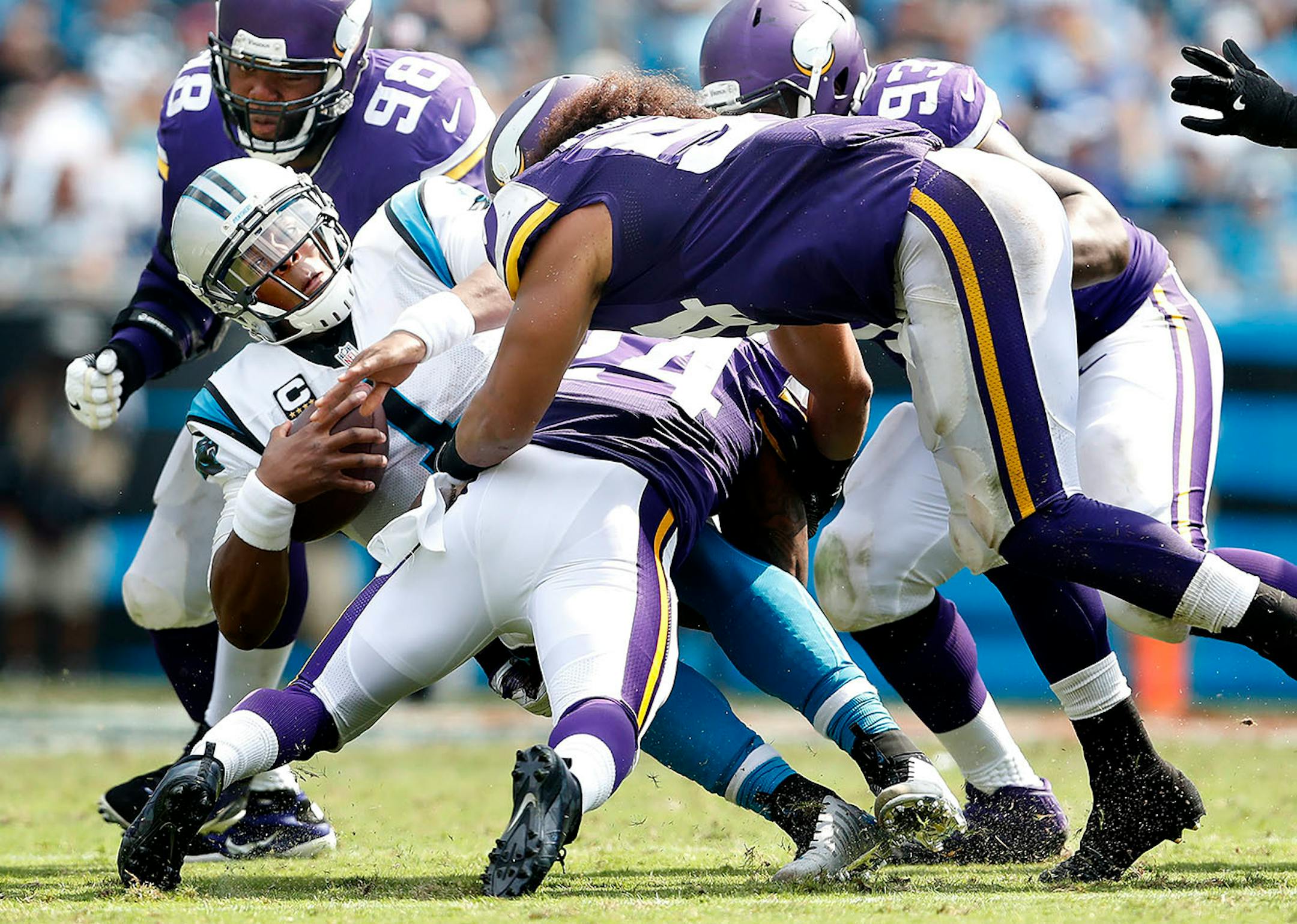 Cam Newton (1) was surrounded by Vikings defenders Linval Joseph (98), Eric Kendricks (54) and Captain Munnerlyn (24) in the third quarter.