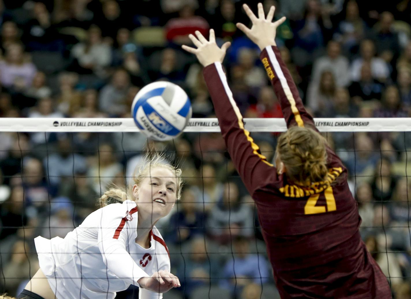 Stanford's Kathryn Plummer, left, drives a spike past Minnesota's Regan Pittman (21) for a point during the semifinals of the NCAA Division I women's volleyball championships Thursday, Dec. 19, 2019, in Pittsburgh. (AP Photo/Keith Srakocic)